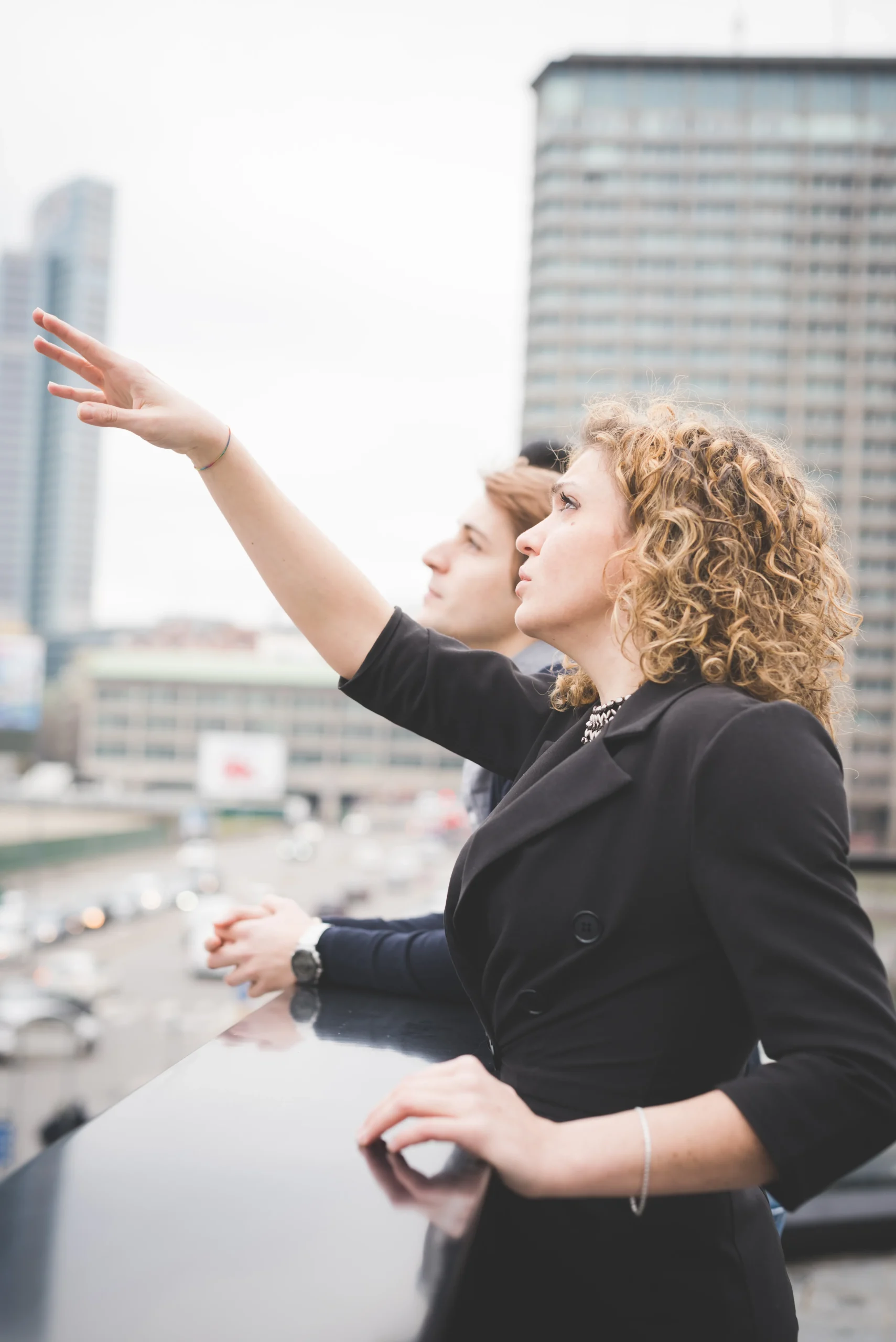 woman-pointing-forward-next-to-a-young-adult-2026-01-05-05-38-59-utc