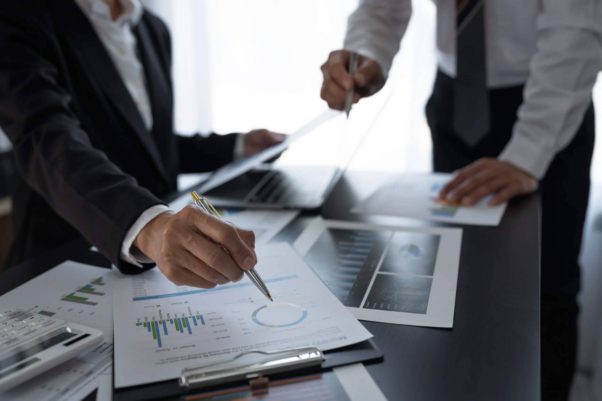 businesspeople-reviewing-charts-and-graphs-in-offi-2026-01-08-02-27-18-utc