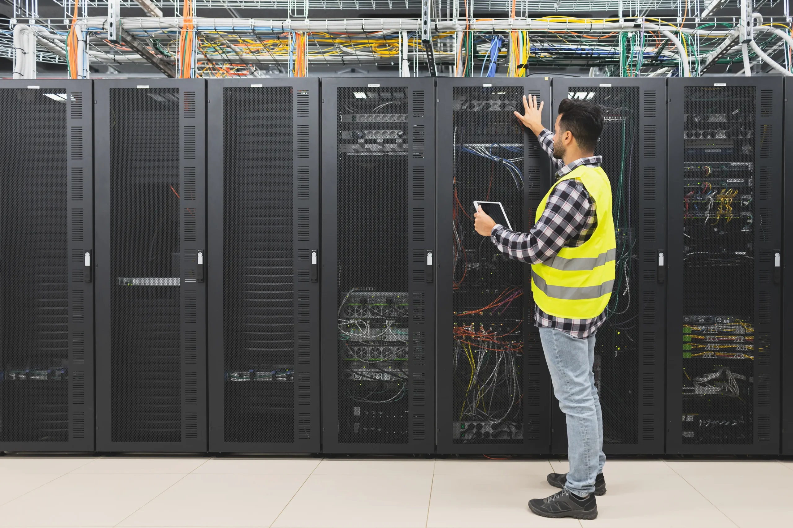 technician-inspecting-server-room-with-digital-tab-2026-01-06-09-15-49-utc